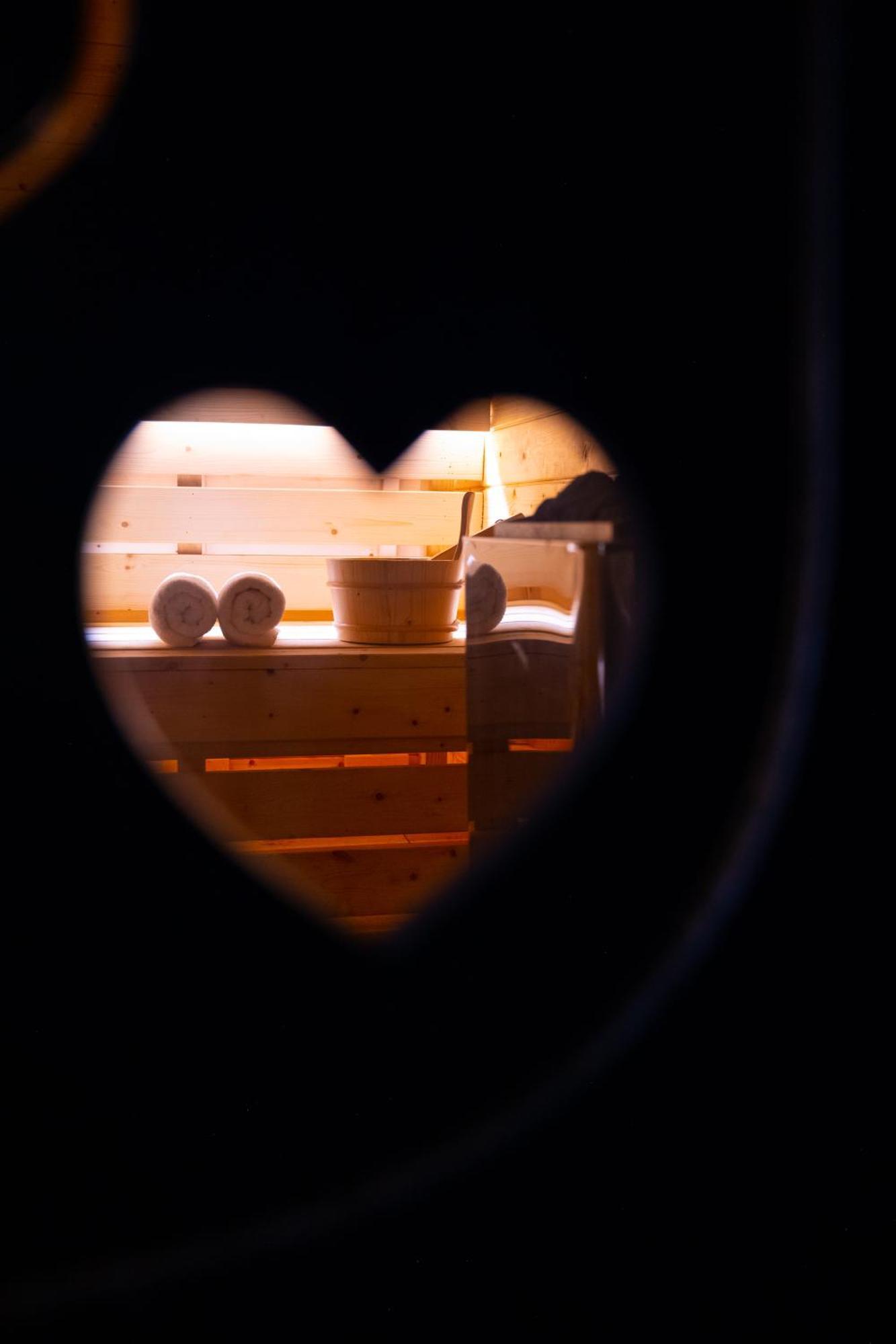 Arka Art Hotel Tirana Bagian luar foto A heart-shaped hole in a sauna door